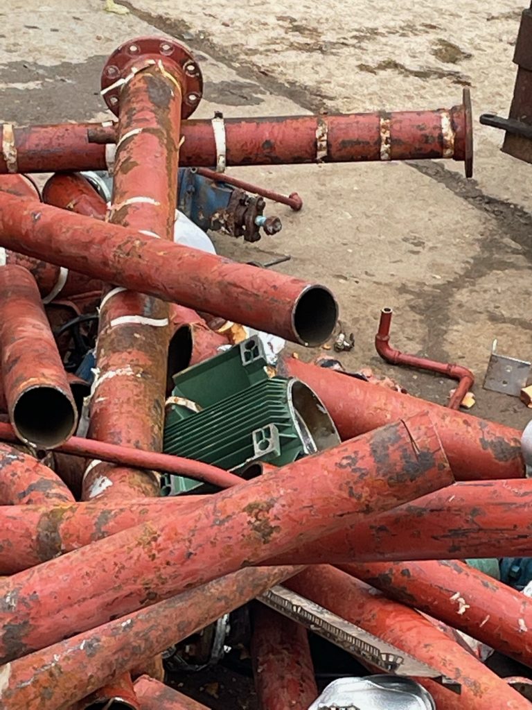 Pile of red scrap metal pipework